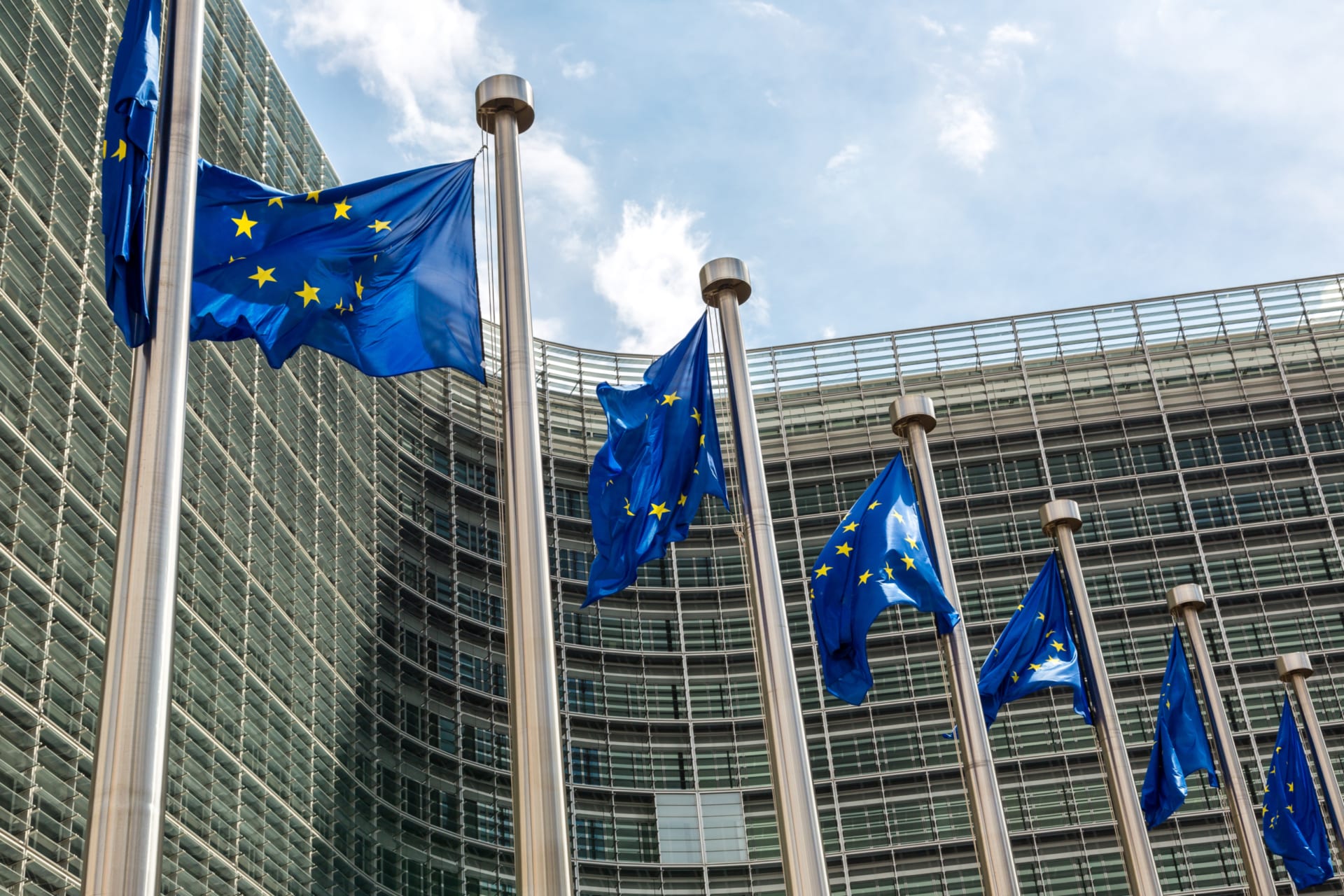 European flags in front of headquarters of European commission in Brussels in summer day.